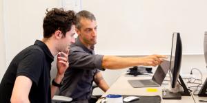 2 researchers facing a computer monitor