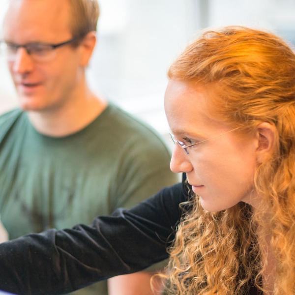 Two people looking at a monitor together
